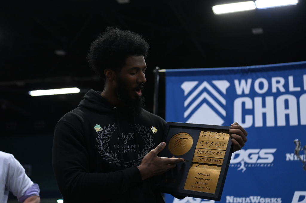 Michael Johnson holding his Coach of the Year award at the 2023 World Ninja League Championships