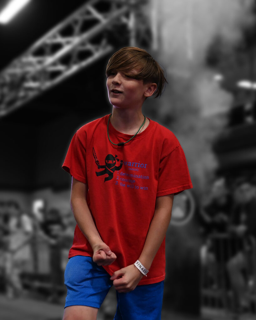 Excited kid hits buzzer at the World Ninja League Championships.